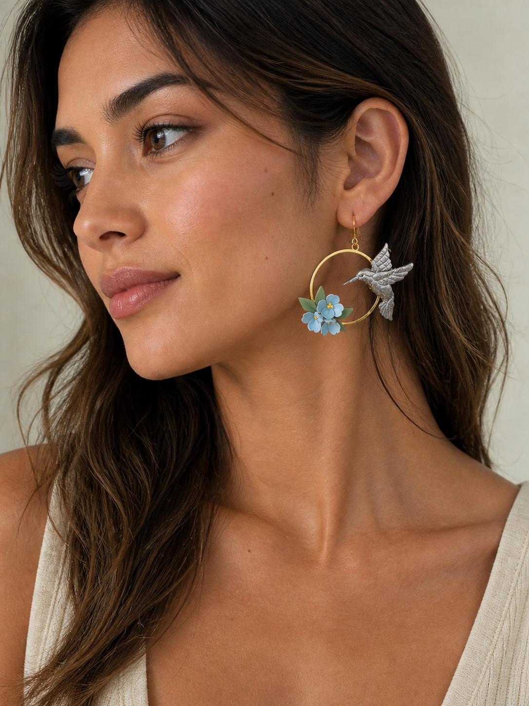 model wearing a hummingbird floral earring