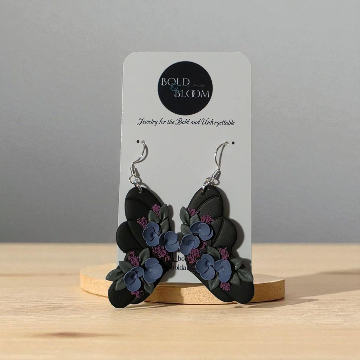 Black Butterfly Statement Earrings with purple and blue flowers